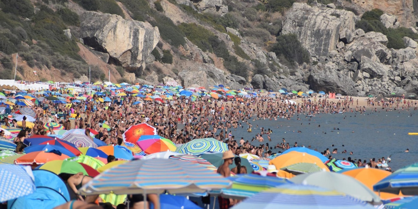 Masse mennesker på stranden på sommeren